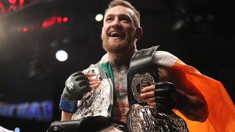 Conor McGregor poses withthe UFC featherweight and lightweight belts in 2016