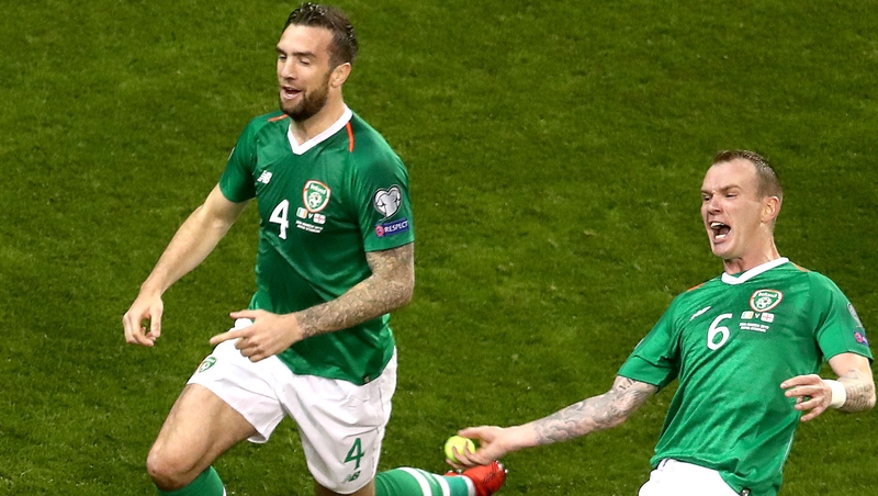 Glenn Whelan celebrates by flinging a tennis ball back into the crowd