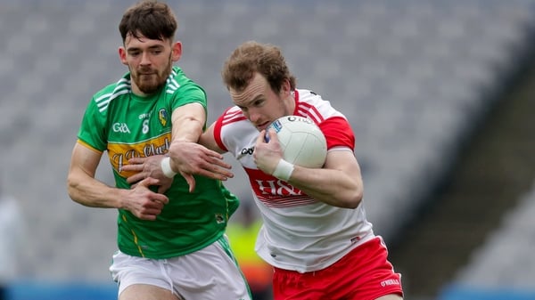 Leitrim's Mark Plunkett with Padraig Cassidy of Derry