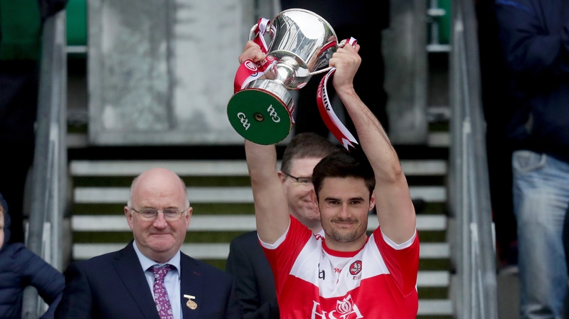 Derry captain Chrissy McKaigue lifts the trophy