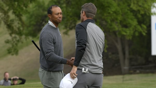 Lucas Bjerregaard of Denmark shakes hands with Tiger Woods