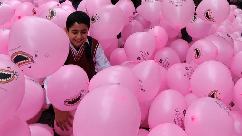 A student plays with pink balloons during April Fool day celebrations in Istanbul. Photo: Mustafa Ozer/AFP/Getty Images