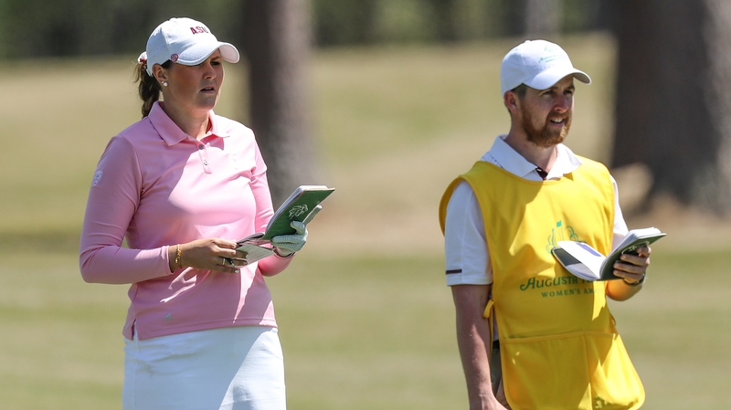 Olivia Mehaffey consults her with caddie ahead of her approach to the 18th hole