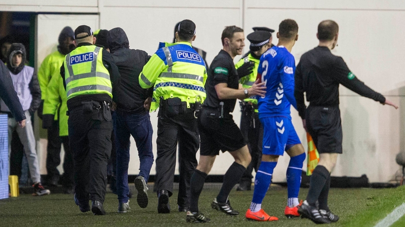 Mack is led away after the incident with Tavernier (in blue)
