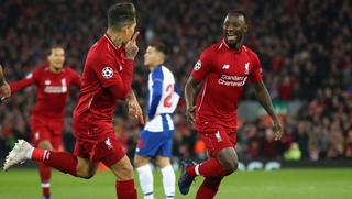 Roberto Firmino and Naby Keita celebrate the opening goal at Anfield