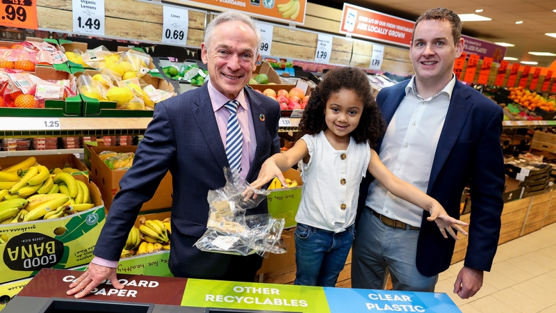 Amelia-Lily Nwanguma, from Rialto in Dublin gives Minister Richard Bruton and JP Scally, Managing Director, Lidl Ireland, a helping hand to launch Lidl's new in-store recycling stations