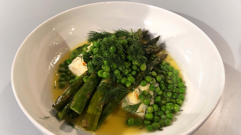 Baked hake with peas and asparagus in lemon butter