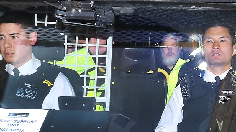 Julian Assange pictured as he left court in London yesterday