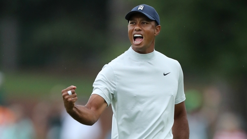 Tiger Woods punches the air after his birdie on the 15th hole