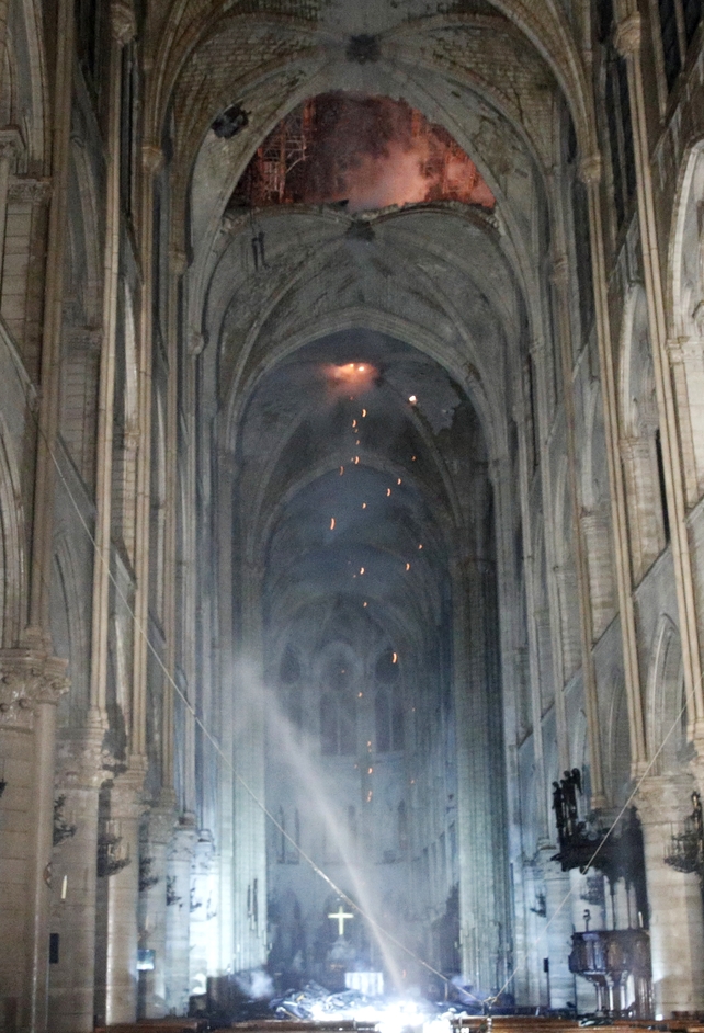 General view of the interior of the cathedral as flames are burning the roof