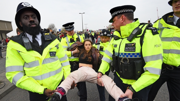 A protester is carried away by police