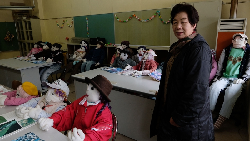 12 colourful child-sized dolls have been placed at desks in the local school - which has no 'real' students