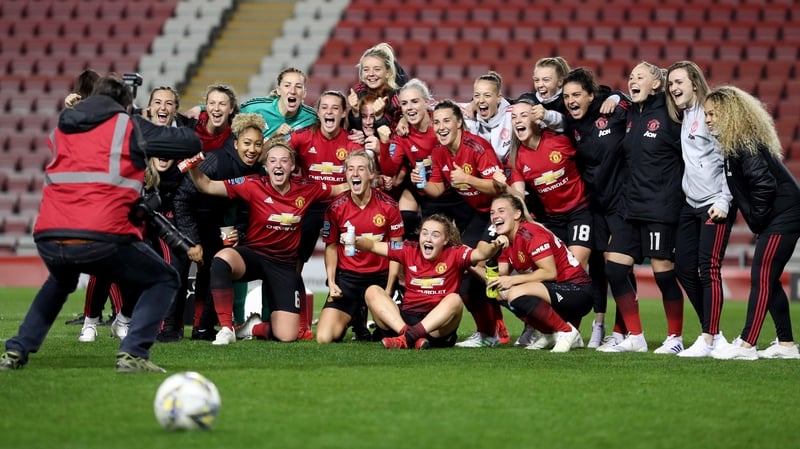 The Manchester United team celebrate after securing promotion