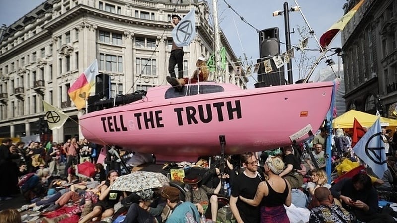 Climate change activists from the Extinction Rebellion group block the road junction at London's Oxford Circus in April 2019
