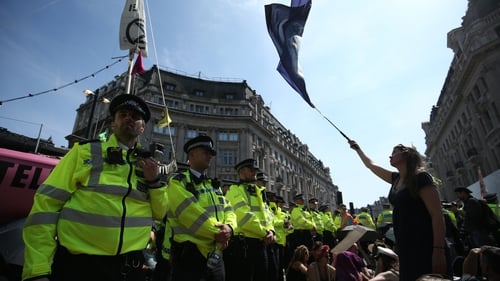 Police surround a pink boat on London's Oxford Street