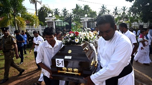 Priests and relatives carry the coffin of a bomb blast victim after a funeral service at St Sebastian's Church in Negombo