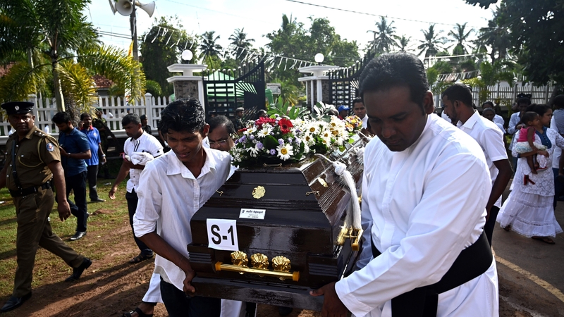 Priests and relatives carry the coffin of a bomb blast victim after a funeral service at St Sebastian's Church in Negombo