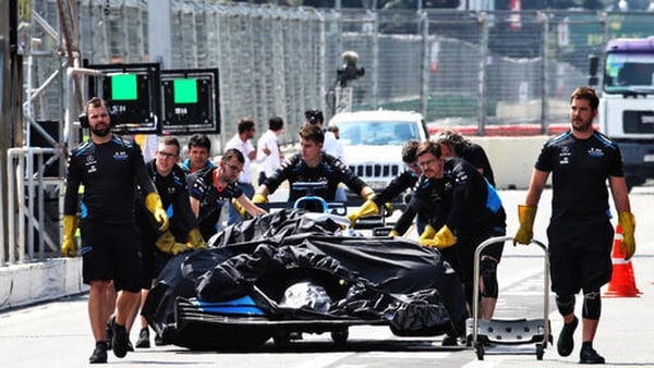 George Russell's Williams car is rolled back to the pits