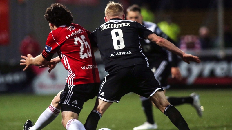 Barry McNamee went down under this challenge from Conor McCormack - the penalty was missed but Cork had to play out the remaining minutes with ten men