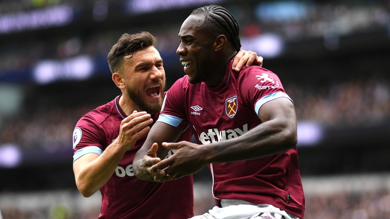 Michail Antonio of West Ham United celebrates with teammate Robert Snodgrass