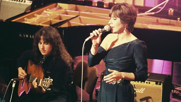 Astrud Gilberto performs on stage in a black dress