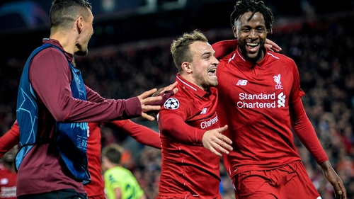 Xherdan Shaqiri (C) celebrates with Divock Origi (R) after his teammate scores the winner