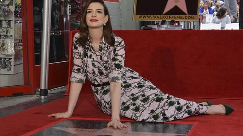 Anne Hathaway posing with her Walk of Fame star