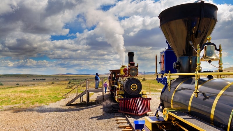 Two replica trains facing each other on railroad tracks at Golden Spike National Historic Site in Utah