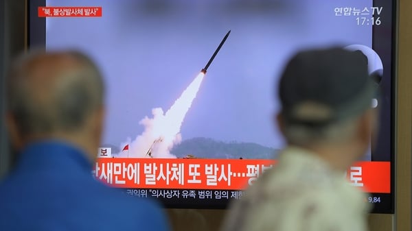 People watch a news programme showing file footage of North Korea's projectile weapons, at a railway station in Seoul
