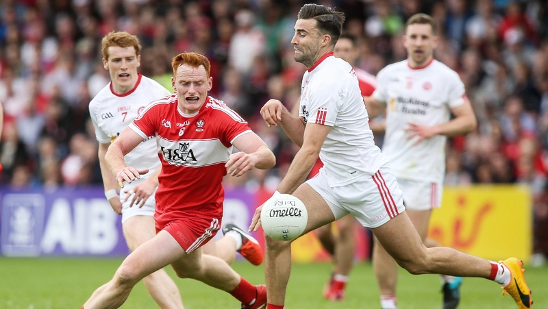 Derry's Conor McAtamney and Tiernan McCann of Tyrone battle for possession in their 2017 Ulster SFC clash