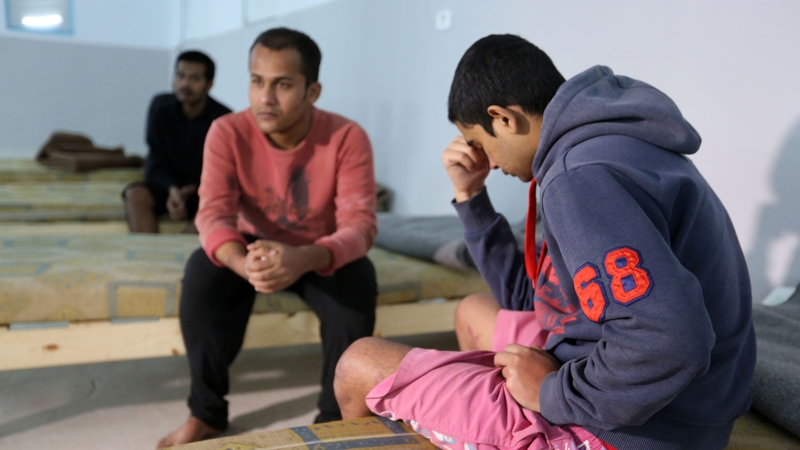 Survivors of a boat carrying migrants that sunk in the Mediterranean gather at a shelter in the Tunisian coastal town of Zarzis