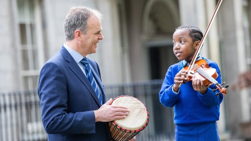 Shammah, (right) who is learning violin as part of the Music Generation programme in South Dublin, with (left) Minister for Education and Skills, Joe McHugh T.D