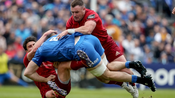 Munster's Joey Carbery and Dave Kilcoyne tackle Jack Conan