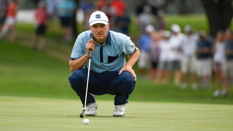 Jordan Spieth reads his putt on the sixth green