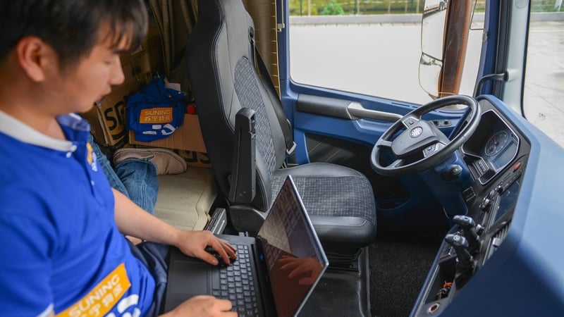An engineer checks on the road behaviour of an autonomous truck.