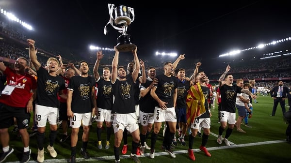 Valencia players celebrate with the trophy