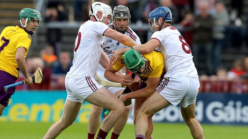 Wexford's Conor McDonald is tackled by Cathal Mannion, Aidan Harte and Johnny Coen