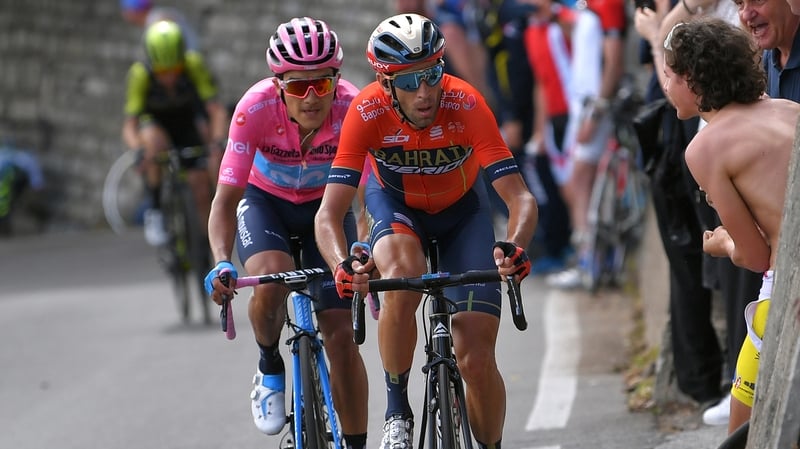Race leader Richard Carapaz keeps a close eye on rival Vincenzo Nibali heading up the mountains on stage 15