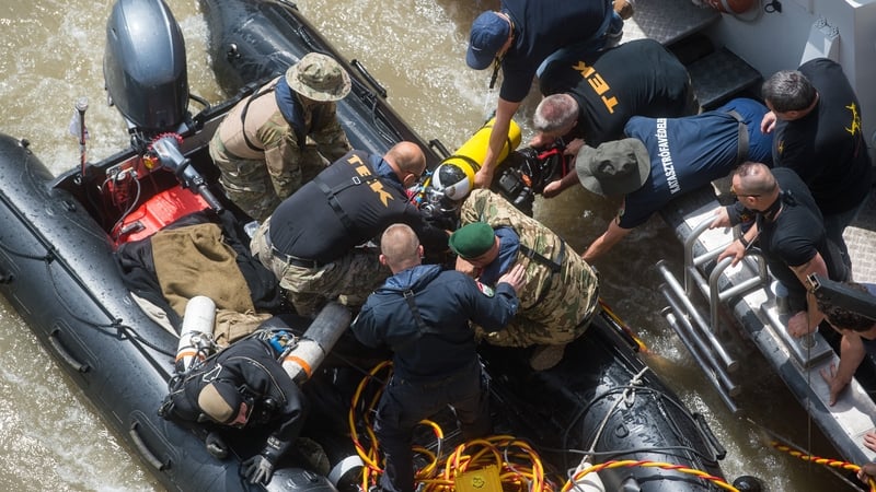 A diver gets out of the water after diving to the wreckage under Margaret Bridge in Budapest