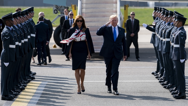 President Trump salutes as he and his wife disembark Air Force One