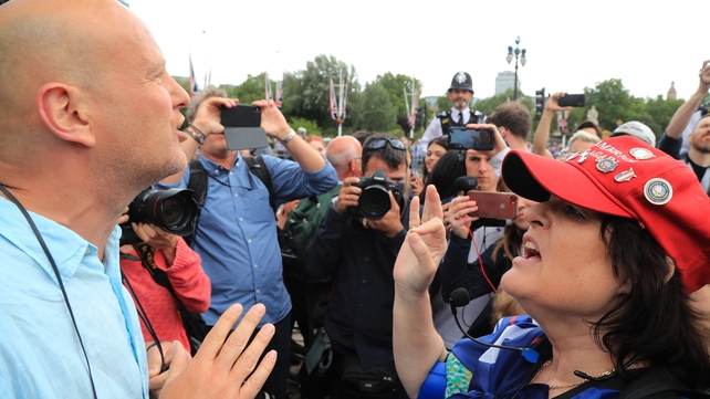 A protester (left) and a Trump supporter exchange views outside Buckingham Palace