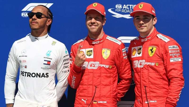 Sebastian Vettel gestures his number one place on the grid ahead of Sunday's grand prix