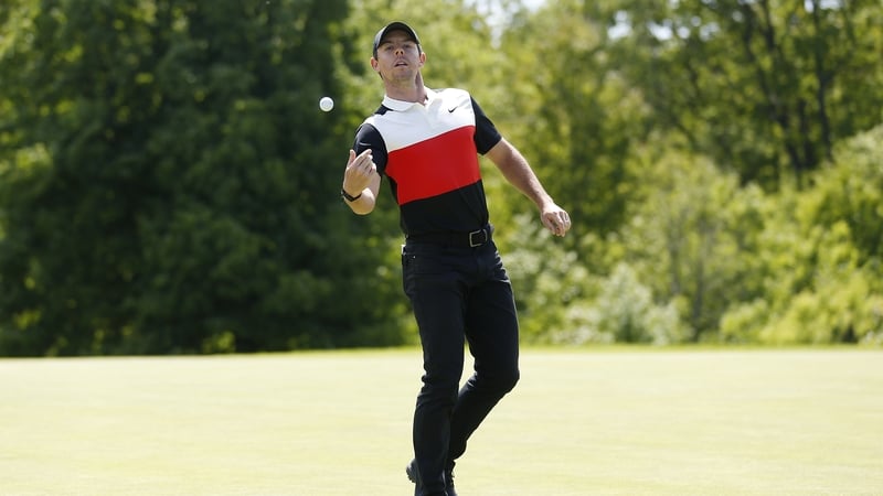 Rory catches his ball following his hole-out for birdie on the eighth