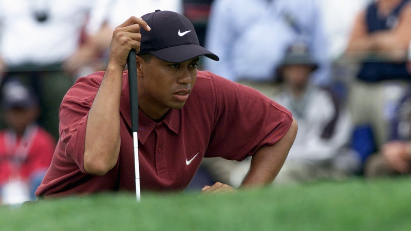 Tiger Woods lines up a putt on the first green during the final round of the 100th U.S. Open at Pebble Beach in 2000