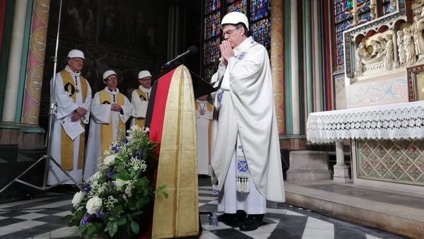 Priests and worshippers wore hard hats to protect themselves against possible falling debris during the ceremony