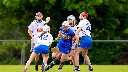 Tipperary's Gemma Grace looks to evade a huddle of Waterford players