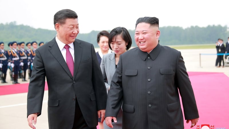 A photo released by the official North Korean Central News Agency (KCNA) shows Xi Jinping being welcomed Kim Jong-Un welcoming