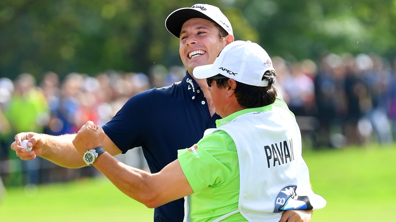 Andrea Pavan celebrates with his caddie on the 18th green at Golfclub Munchen Eichenried