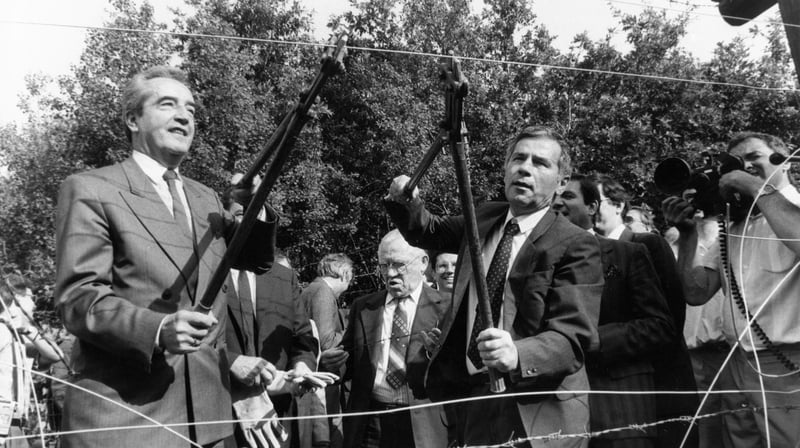 Austrian Foreign Minister Alois Mock (left) and his Hungarian counterpart Gyula Horn cut the barbed wire in Sopron, a Hungarian border town near Austria