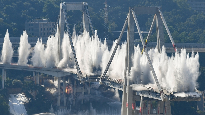 Explosive charges blow up the eastern pylons of Genoa's Morandi motorway bridge